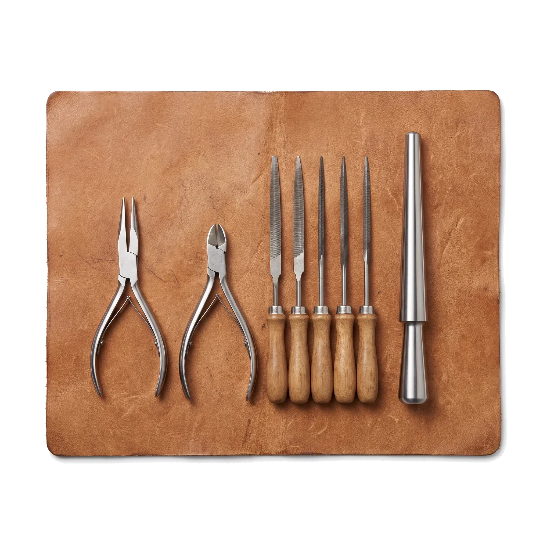 Jeweller's pliers, side cutters, needle files and a ring mandrel laid in a row on a leather bench skin.