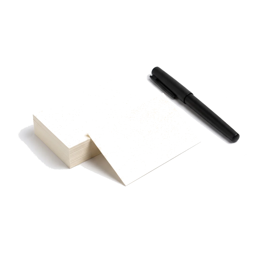 A small stack of blank cream cards beside a fountain pen.