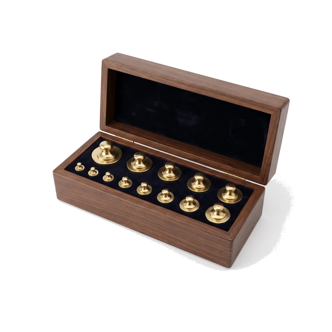 An open wooden box of graded brass calibration weights, each in its own recess.